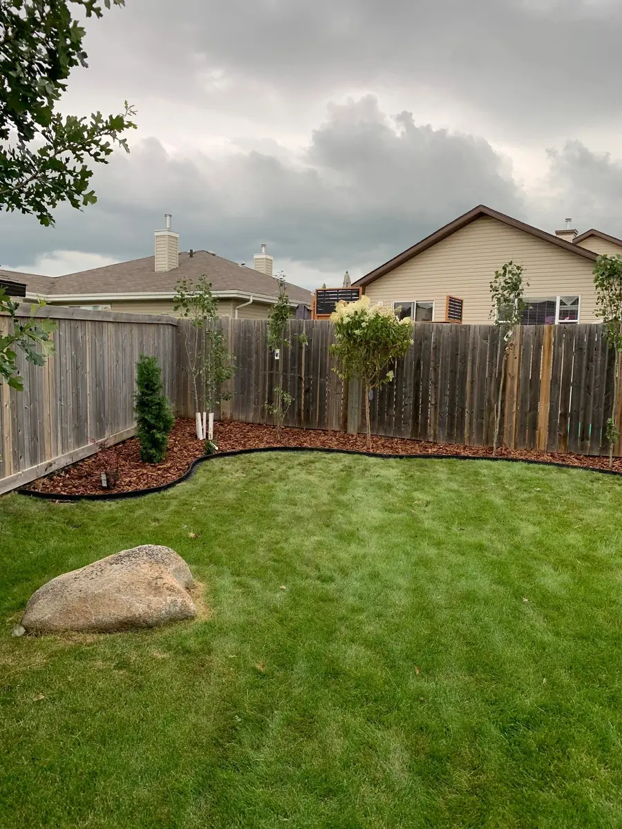 Grass Theory crew maintaining a residential lawn in Morinville, Alberta