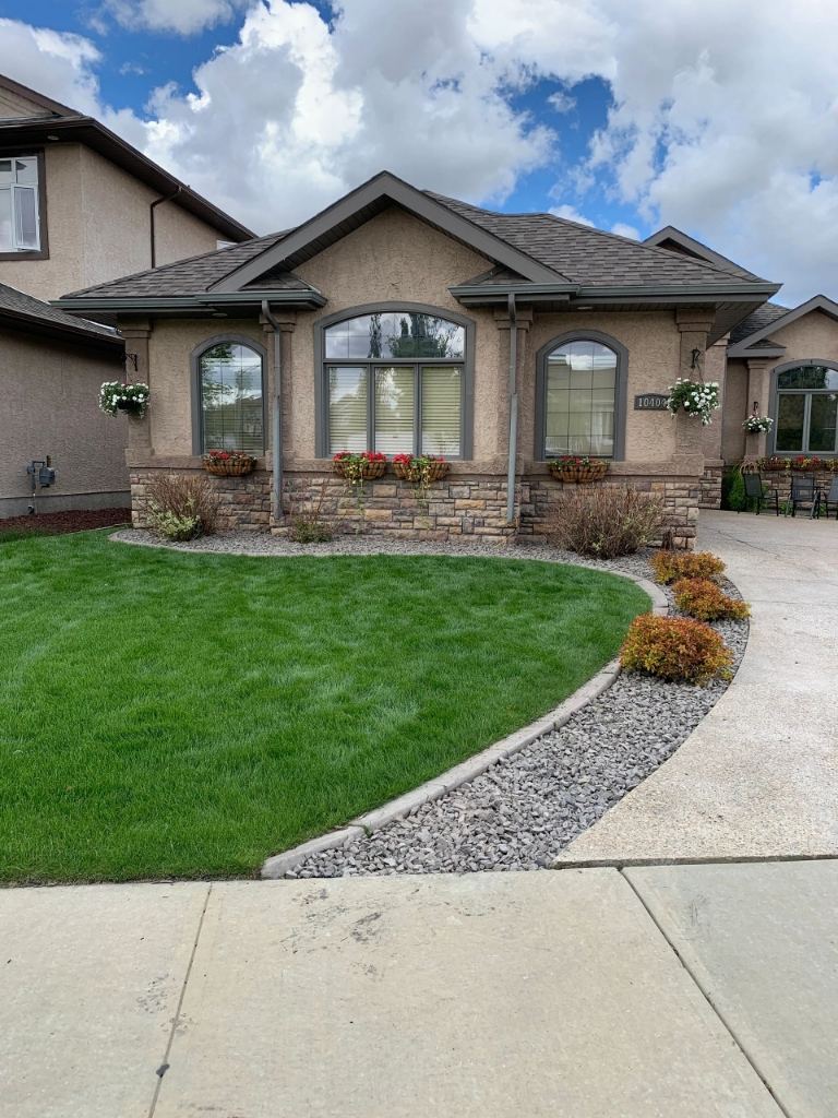 Lush green residential lawn in Morinville after professional mowing and trimming